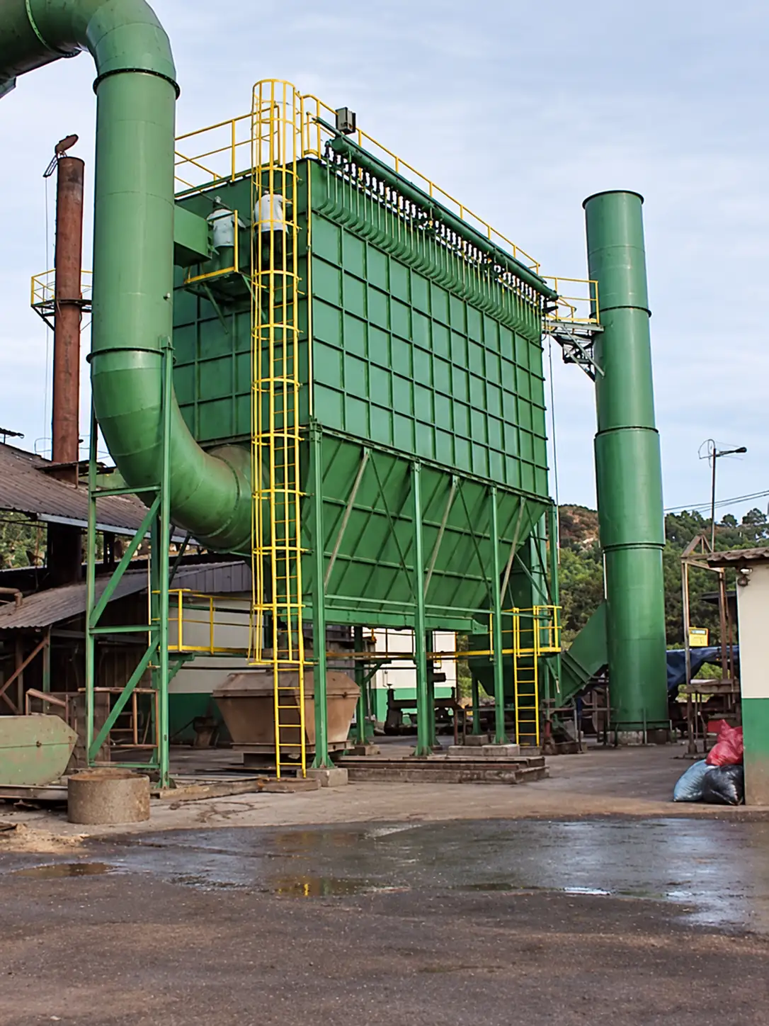 Green baghouse with hoppers, side ducts, and access ladder