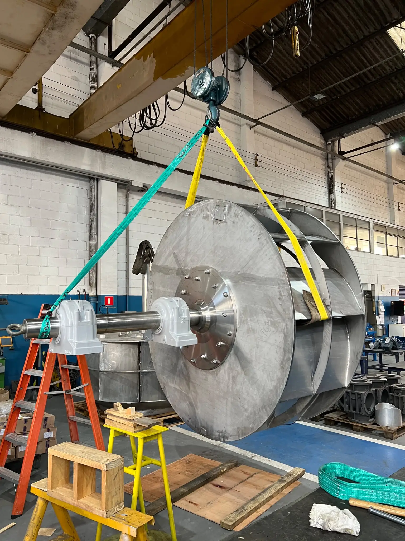 Large impeller with shaft and bearings, suspended by slings at the Kleema factory
